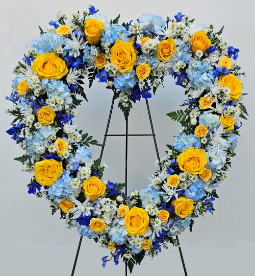 Open Heart Funeral Standing Spray with Blue and Yellow Blooms